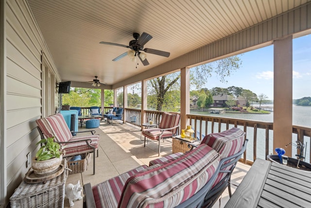 deck featuring a ceiling fan, outdoor dining space, a water view, and an outdoor living space