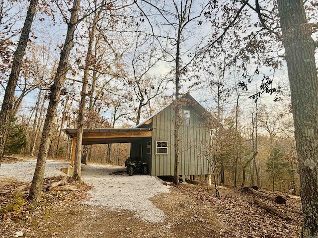 view of outbuilding featuring a carport and driveway