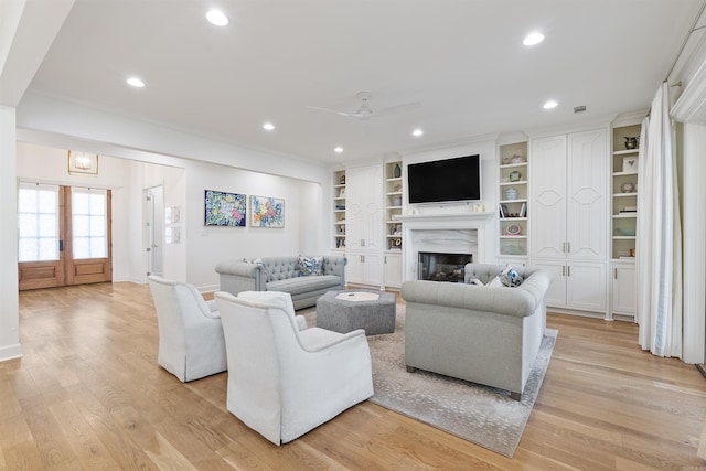 living area with light wood-style flooring, a fireplace, recessed lighting, and ceiling fan
