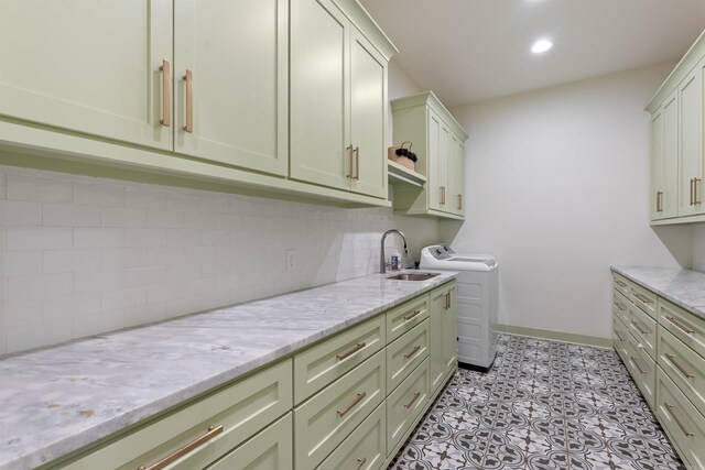 laundry area with baseboards, cabinet space, a sink, and recessed lighting
