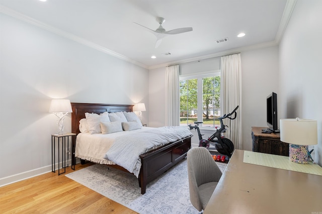 bedroom featuring light wood-type flooring, baseboards, visible vents, and crown molding