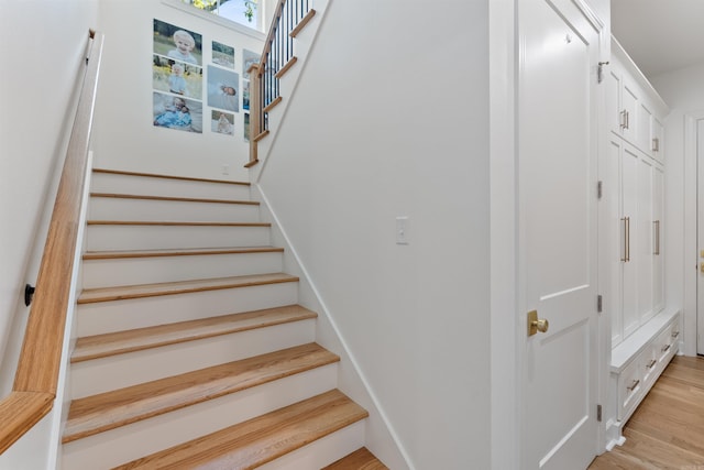 stairs featuring wood finished floors