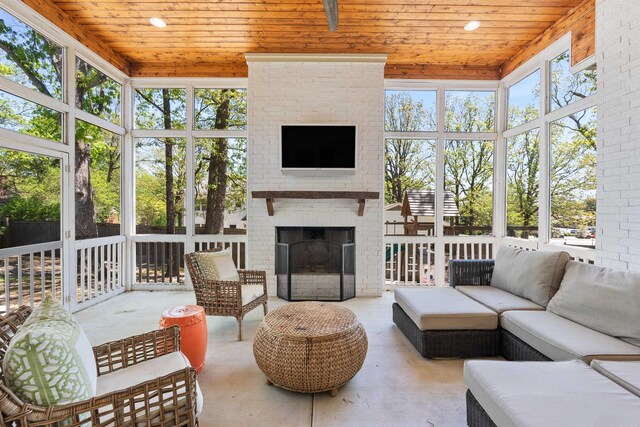 sunroom / solarium featuring an outdoor living space with a fireplace