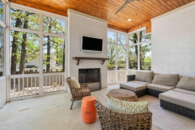 sunroom / solarium featuring an outdoor living space with a fireplace