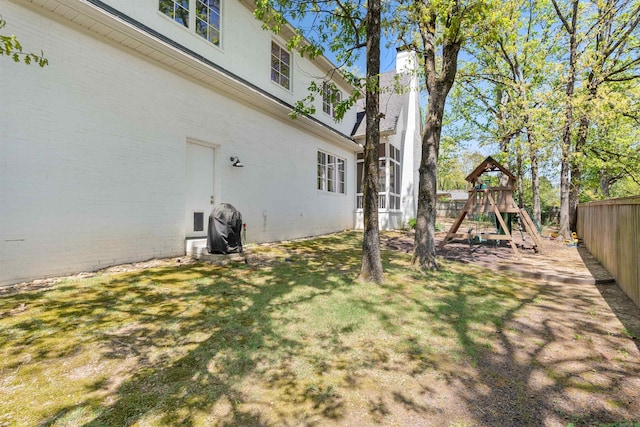 view of yard featuring a fenced backyard and a playground