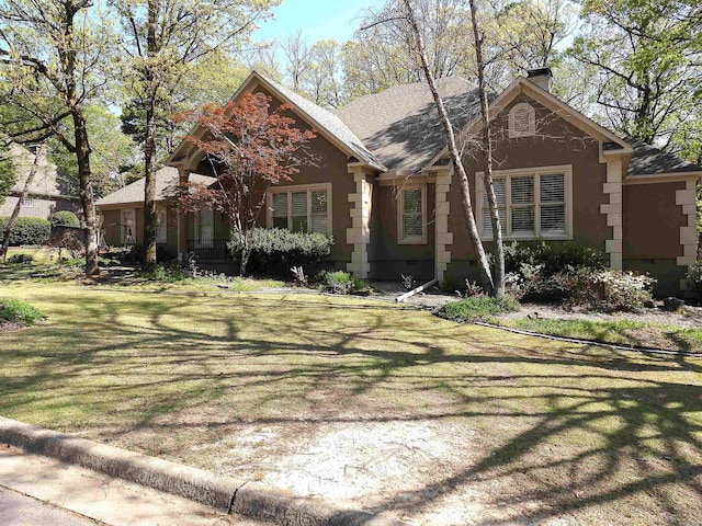 22 Talais Dr, Little Rock, AR 72223 - view of front of home with a front lawn, roof with shingles, a chimney, and stucco siding