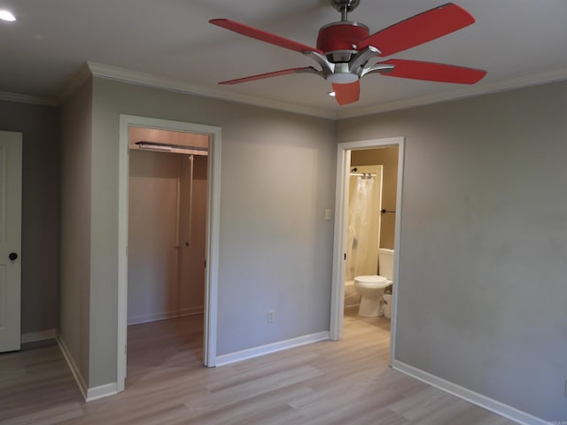 22 Talais Dr, Little Rock, AR 72223 - unfurnished bedroom featuring a walk in closet, light wood-type flooring, a closet, crown molding, and baseboards