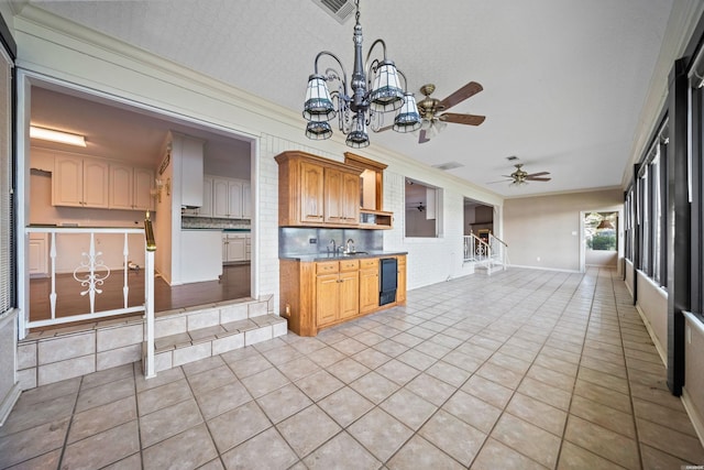 118 Grandview Dr, Hot Springs, AR 71913 - kitchen with ceiling fan with notable chandelier, open floor plan, light tile patterned flooring, ornamental molding, and visible vents