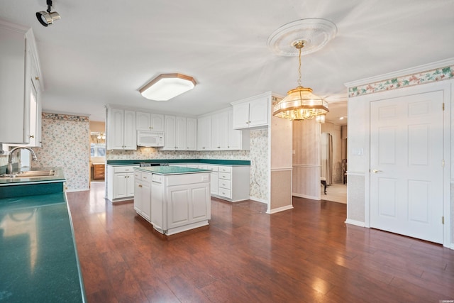 118 Grandview Dr, Hot Springs, AR 71913 - kitchen featuring a sink, a chandelier, white microwave, white cabinets, and dark wood-type flooring