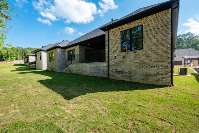219 Abington Cir, Little Rock, AR 72223 - back of house featuring central AC unit, a yard, and brick siding