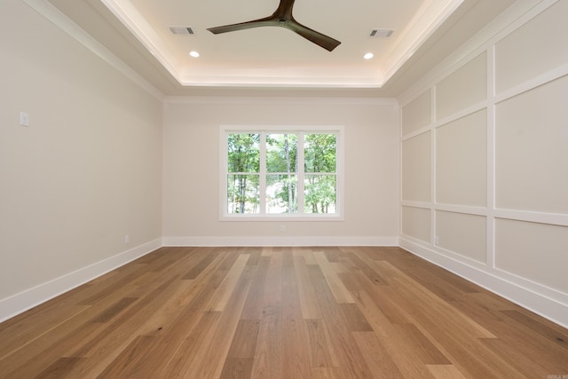219 Abington Cir, Little Rock, AR 72223 - spare room featuring visible vents, baseboards, a raised ceiling, ceiling fan, and light wood-style floors