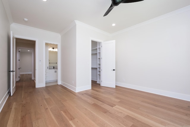 219 Abington Cir, Little Rock, AR 72223 - unfurnished bedroom featuring light wood-type flooring, a spacious closet, baseboards, and crown molding
