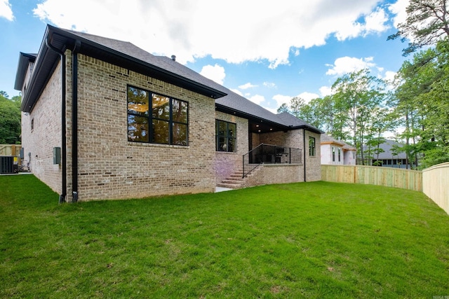 219 Abington Cir, Little Rock, AR 72223 - back of property with fence, stairs, brick siding, a yard, and central AC unit