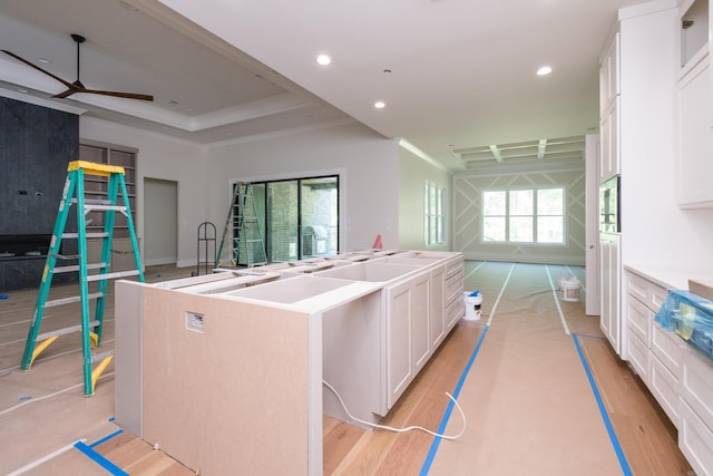 219 Abington Cir, Little Rock, AR 72223 - kitchen featuring a ceiling fan, open floor plan, a center island with sink, white cabinetry, and light wood-style floors
