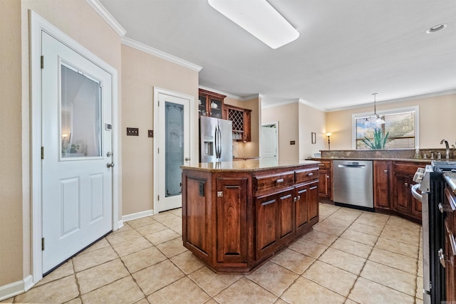 109 Sandstone Cv, Sherwood, AR 72120 - kitchen featuring glass insert cabinets, appliances with stainless steel finishes, crown molding, a kitchen island, and light tile patterned floors