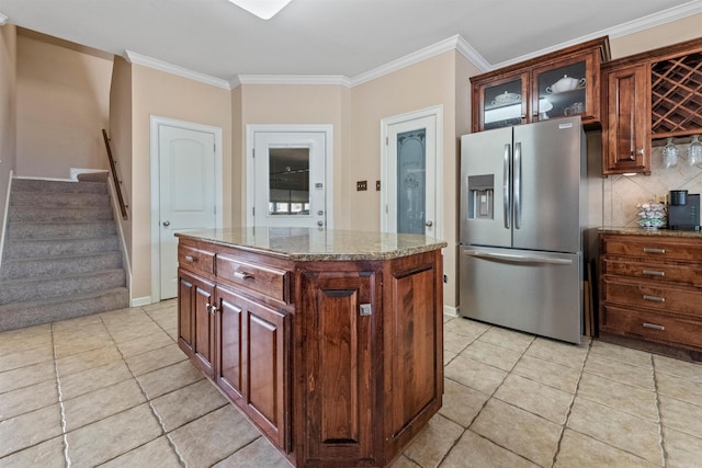 109 Sandstone Cv, Sherwood, AR 72120 - kitchen featuring glass insert cabinets, light tile patterned floors, stainless steel fridge with ice dispenser, backsplash, and ornamental molding