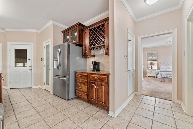 109 Sandstone Cv, Sherwood, AR 72120 - kitchen with ornamental molding, stainless steel fridge with ice dispenser, light tile patterned flooring, and decorative backsplash