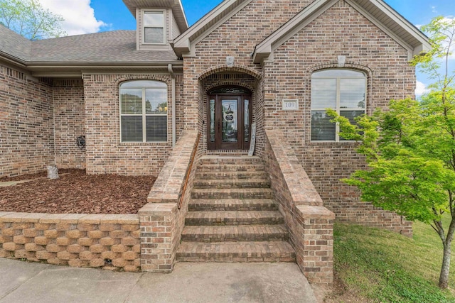 109 Sandstone Cv, Sherwood, AR 72120 - view of exterior entry featuring brick siding and roof with shingles