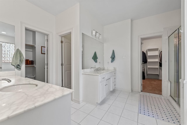 109 Sandstone Cv, Sherwood, AR 72120 - full bath featuring a spacious closet, vanity, tile patterned floors, and a stall shower