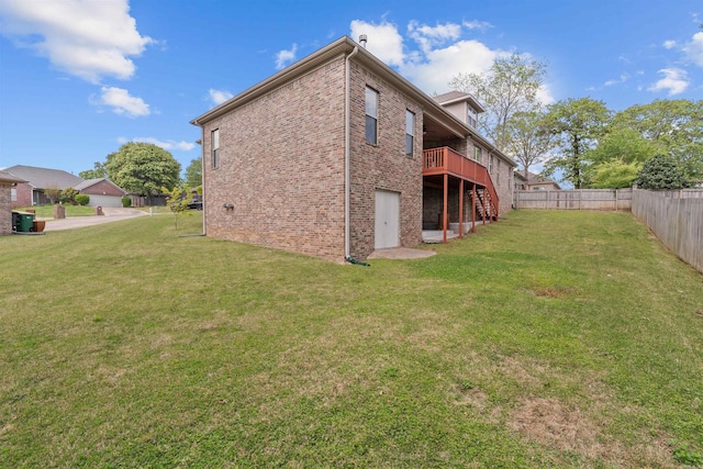 109 Sandstone Cv, Sherwood, AR 72120 - rear view of property with stairway, a deck, a fenced backyard, a yard, and brick siding