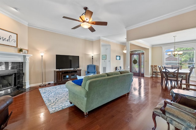 109 Sandstone Cv, Sherwood, AR 72120 - living room with ceiling fan with notable chandelier, baseboards, wood finished floors, and ornamental molding