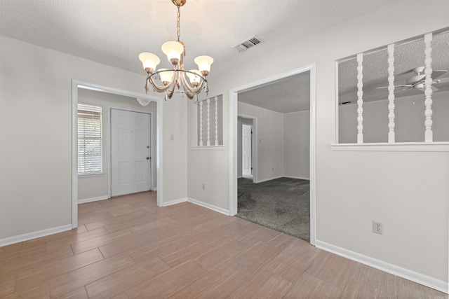 8302 Merriwood Ct, Sherwood, AR 72120 - unfurnished room featuring wood finished floors, a textured ceiling, a chandelier, baseboards, and visible vents