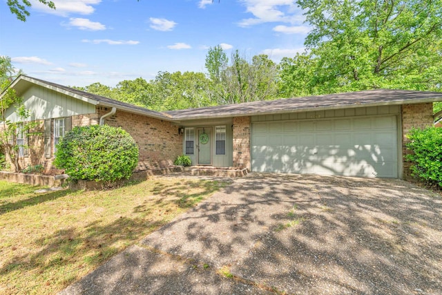 8302 Merriwood Ct, Sherwood, AR 72120 - ranch-style home with an attached garage, aphalt driveway, and brick siding