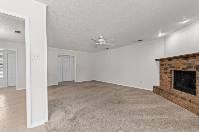 8302 Merriwood Ct, Sherwood, AR 72120 - unfurnished living room with a ceiling fan, a textured ceiling, visible vents, and a fireplace