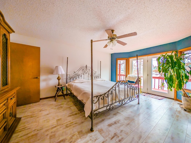 bedroom featuring a ceiling fan, access to exterior, a textured ceiling, and light wood-style flooring