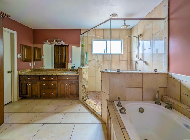 bathroom with tile patterned flooring, a garden tub, vanity, and a stall shower