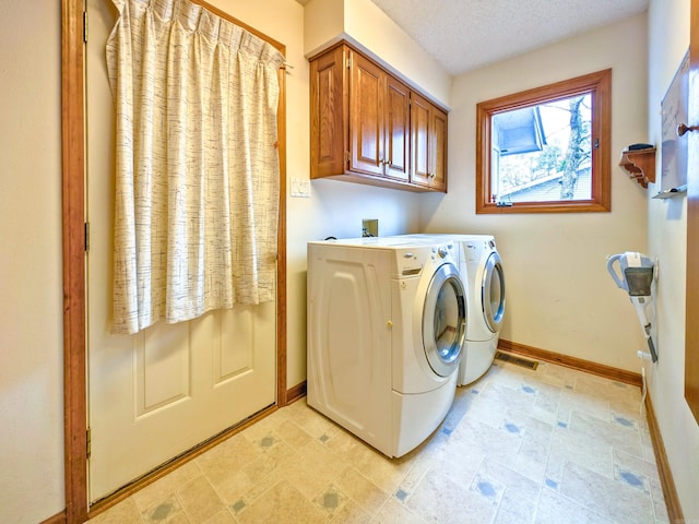 clothes washing area with baseboards, cabinet space, washer and clothes dryer, and visible vents