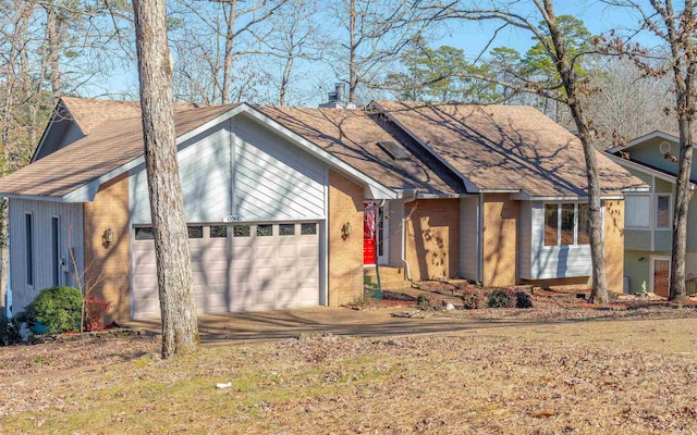 single story home with brick siding, an attached garage, and roof with shingles