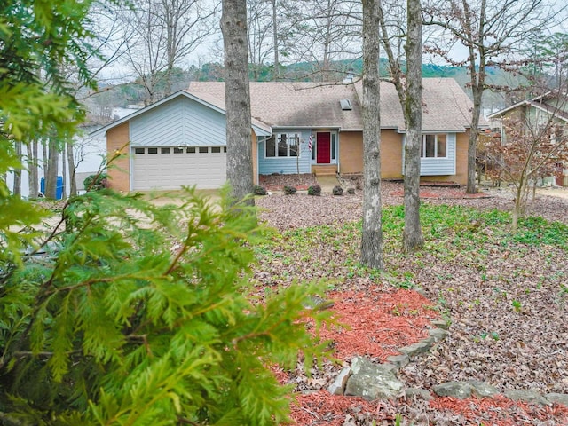 ranch-style house featuring an attached garage, a shingled roof, and driveway