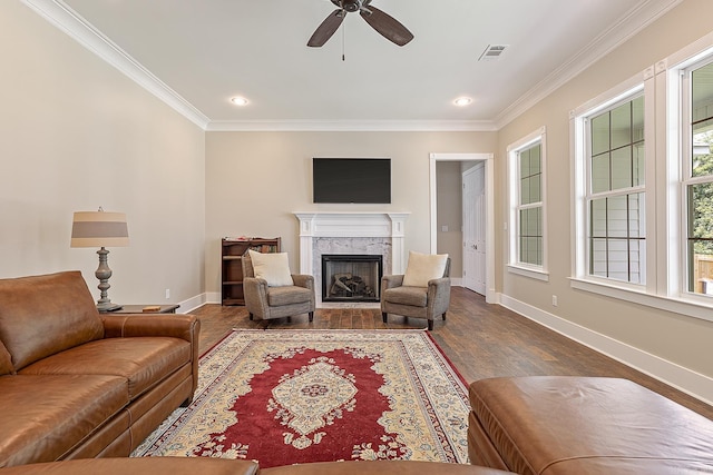 living room featuring a high end fireplace, baseboards, a ceiling fan, and visible vents