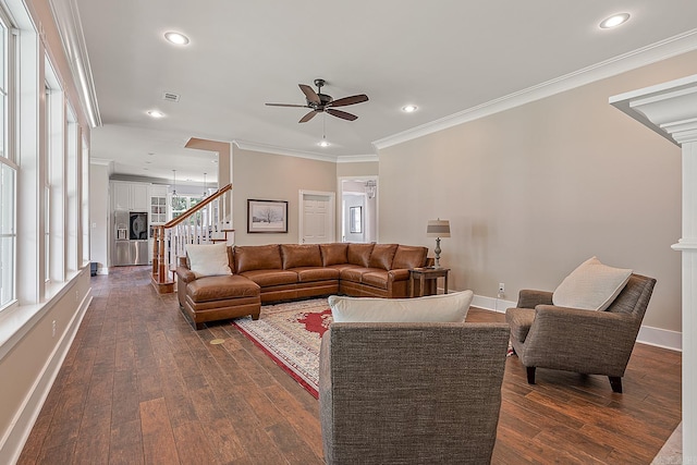 living area featuring stairway, ceiling fan, crown molding, baseboards, and dark wood-style flooring