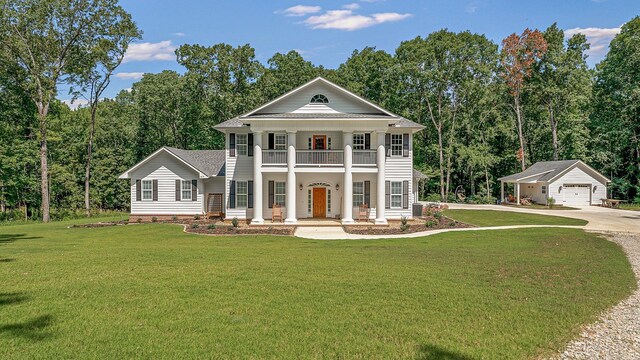 greek revival inspired property featuring driveway, a porch, a balcony, and a front yard