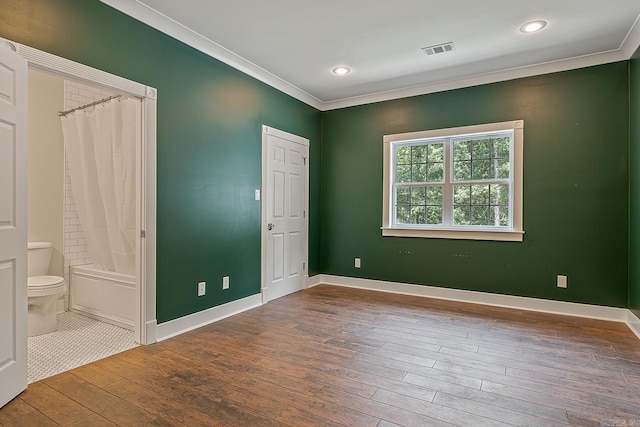 unfurnished bedroom featuring baseboards, visible vents, recessed lighting, crown molding, and hardwood / wood-style flooring