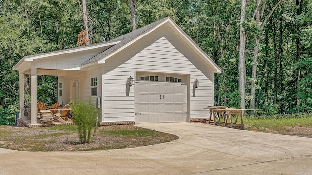 garage featuring concrete driveway