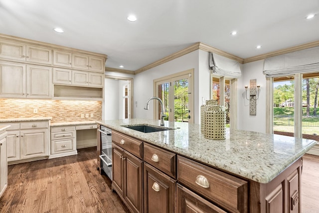 kitchen featuring a wealth of natural light, dark wood-style floors, a sink, and crown molding