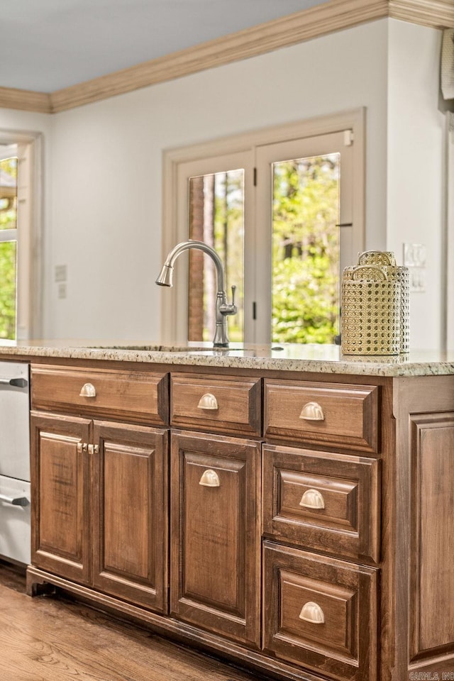 bar with a warming drawer, wood finished floors, and crown molding