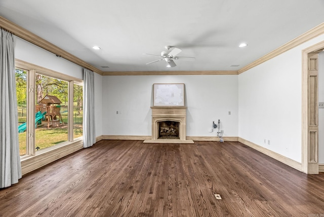 unfurnished living room with baseboards, a fireplace with raised hearth, a ceiling fan, crown molding, and dark wood-type flooring