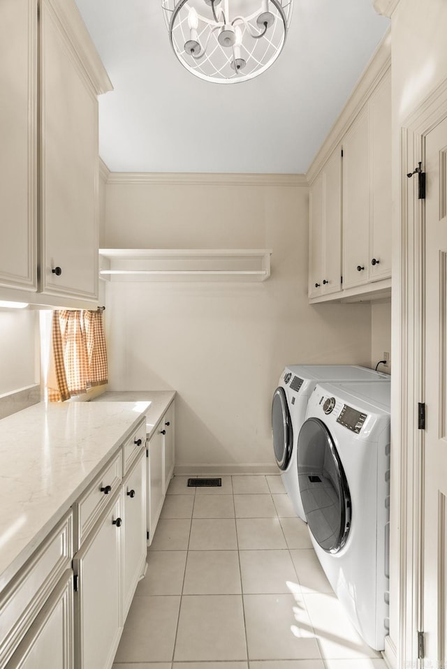 clothes washing area with visible vents, a notable chandelier, cabinet space, washer and dryer, and light tile patterned floors