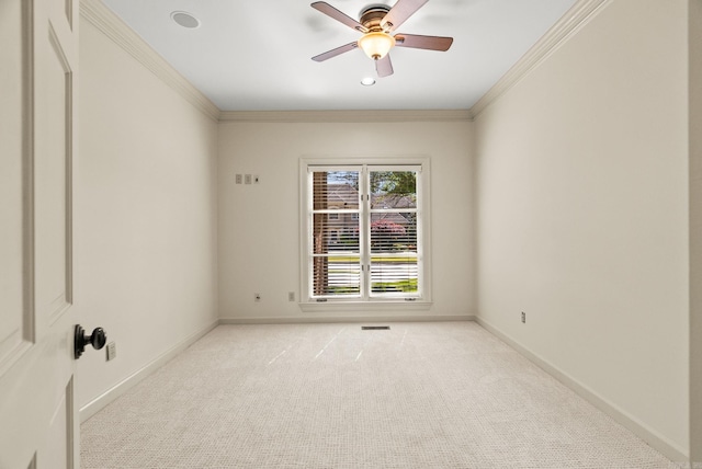 unfurnished room featuring light carpet, a ceiling fan, baseboards, and ornamental molding