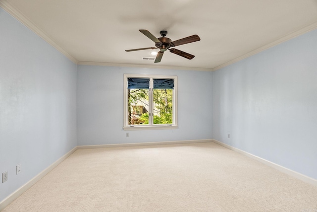 empty room with light carpet, baseboards, visible vents, ceiling fan, and crown molding