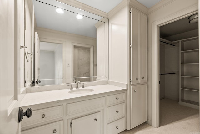 bathroom featuring crown molding, vanity, and a closet