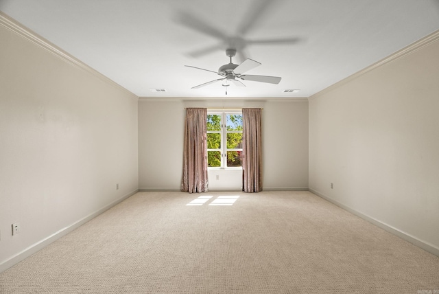 empty room featuring ceiling fan, crown molding, baseboards, and light carpet