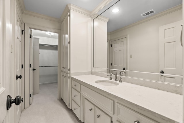 bathroom with ornamental molding, vanity, and visible vents