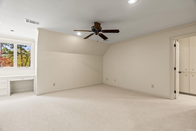 additional living space with light colored carpet, baseboards, a ceiling fan, and visible vents