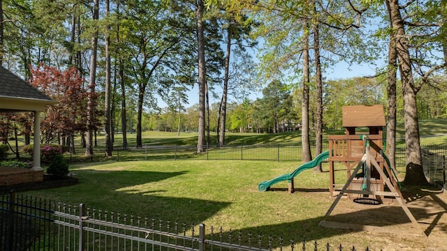 view of playground with a lawn and a fenced backyard