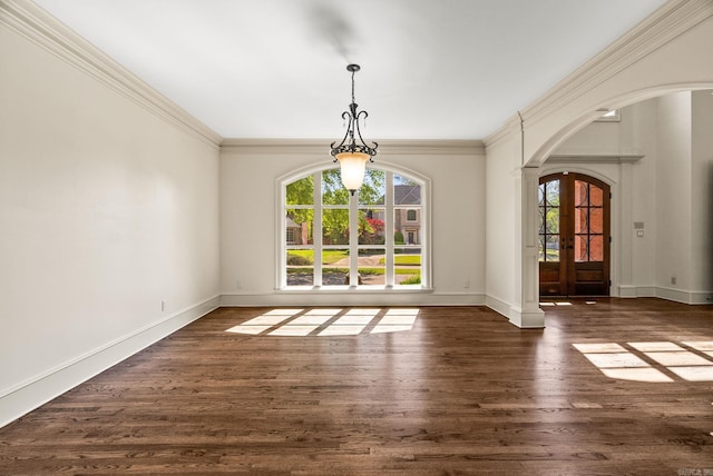 unfurnished dining area featuring arched walkways, baseboards, crown molding, and dark wood-style floors